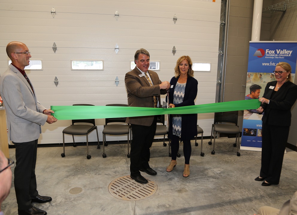 Tony Gonzalez, chair of the FVTC Board of Trustees, and Jackie Weber, president of the FVTC Foundation Board (center), cut the ribbon to dedicate the new Wautoma Regional Center.